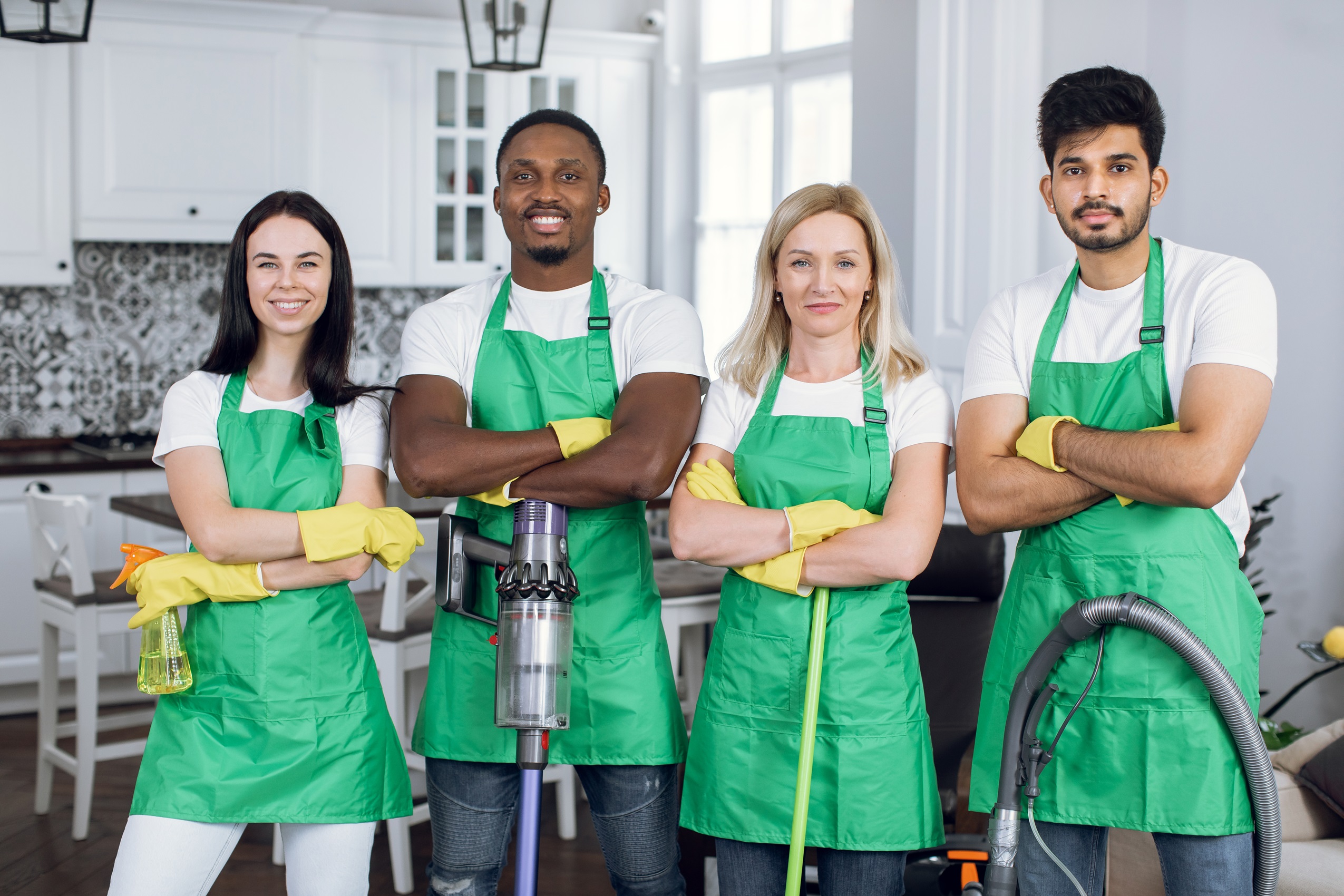 confident mixed race cleaners standing at apartmen 2023 11 27 05 08 54 utc