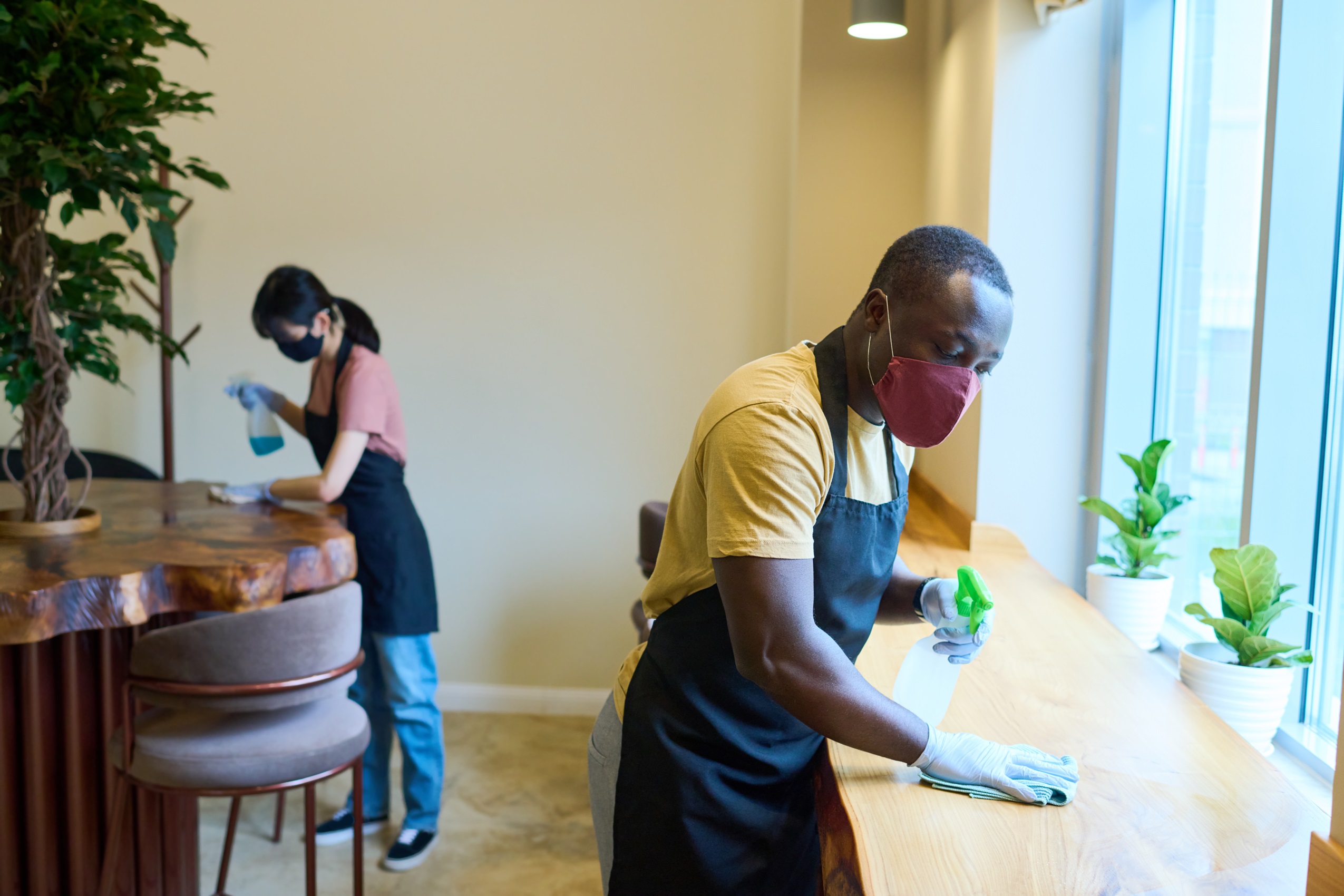 waiters cleaning tables in cafe before opening 2023 11 27 05 34 13 utc